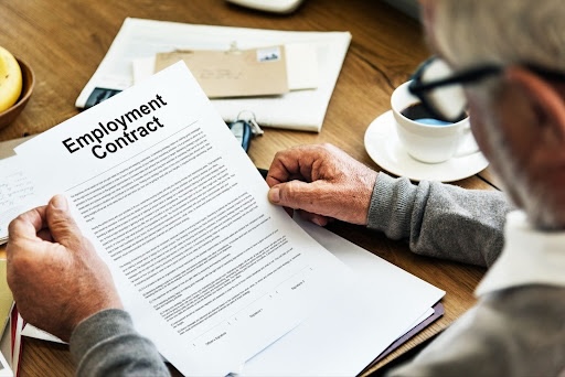 person holding paper that read employment agreement unemployment benefits legal resource nwls
